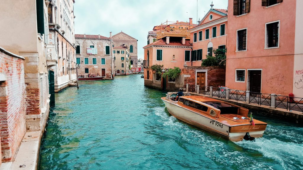 classic wooden boat on a canal in venice italy