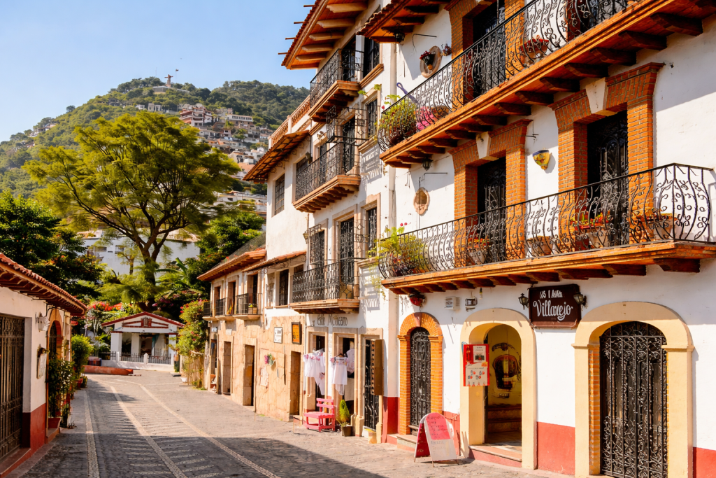 Classic Mexican architecture with the statue of Christ on the hill in the background