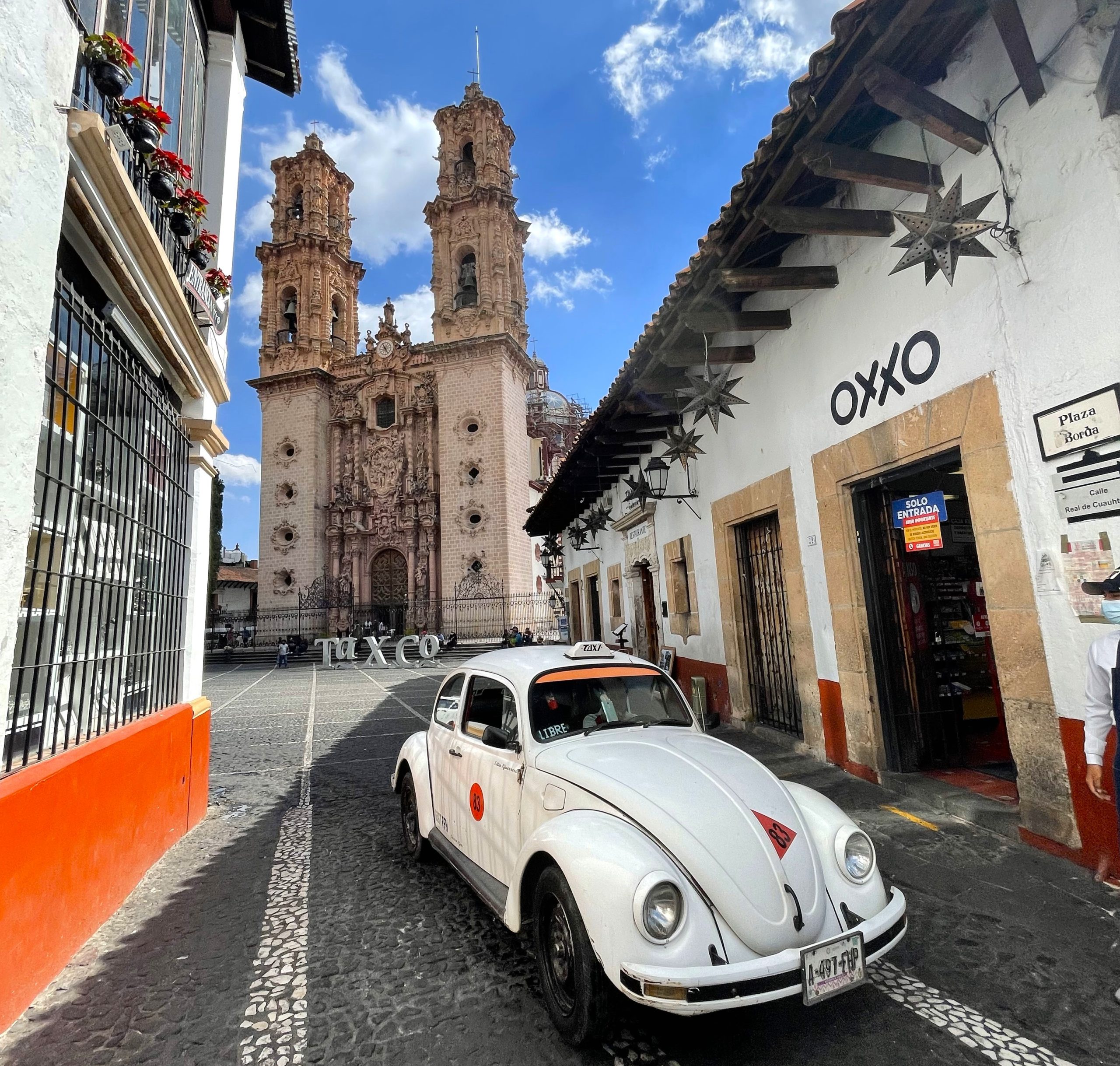 VW beetle taxi in Taxco Mexico in front of a church